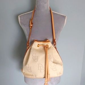 NWT Dooney & Bourke cream canvas drawstring bucket bag. Leather trim.
